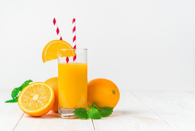 glass freshly squeezed orange juice with slice orange tubes light desk with oranges mint 166116 2516 min